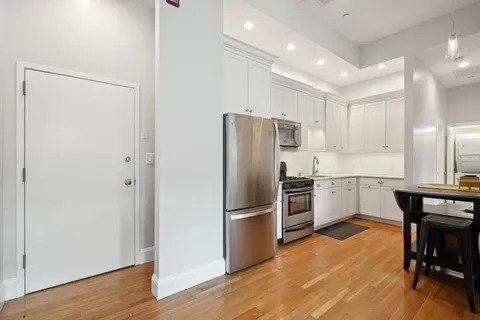 a bedroom with a bed and wooden floor