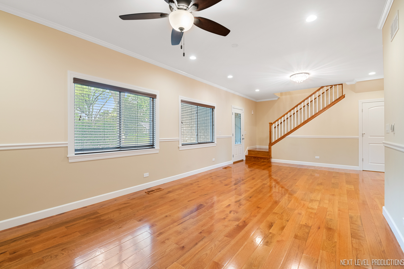 115 Birch Avenue Lake Bluff, IL 60044 - Photo 5 of 39 a view of an empty room with wooden floor and a ceiling fan