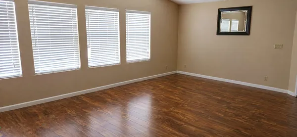 a dining room with furniture and wooden floor