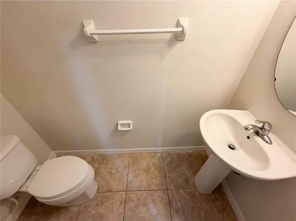a bathroom with a sink mirror and toilet