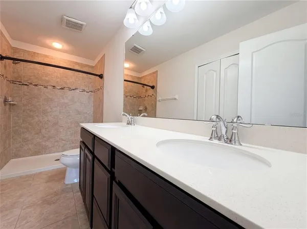 a bathroom with a sink a large mirror and a bathtub