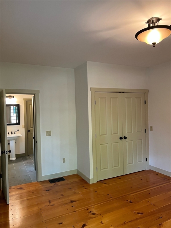 160 Quaker Street Northbridge, MA 01534 - Photo 9 of 36 a view of an empty room with wooden floor and a bathroom