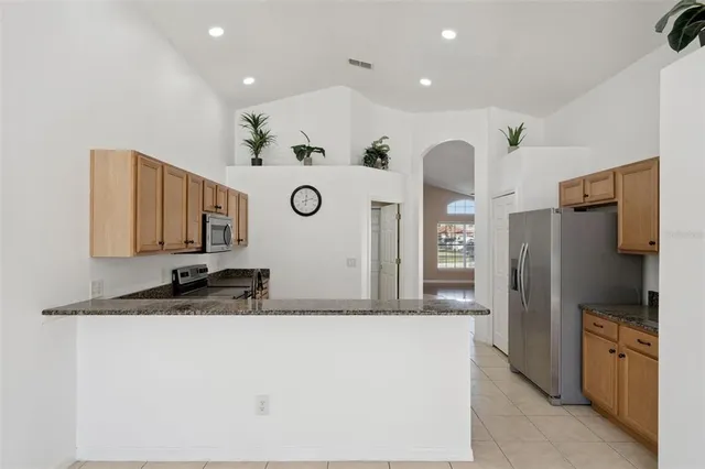 a spacious bathroom with a double vanity sink a mirror and a bathtub