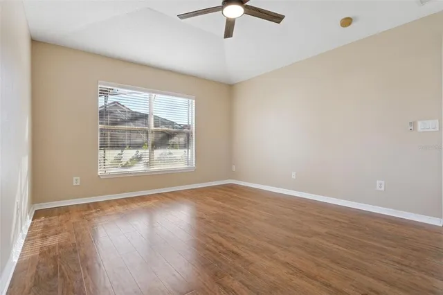 an aerial view of residential houses with outdoor space and ocean view