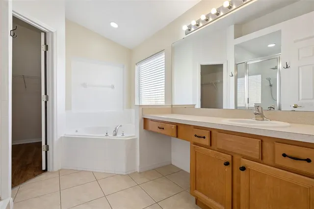 an aerial view of residential houses with outdoor space and ocean view