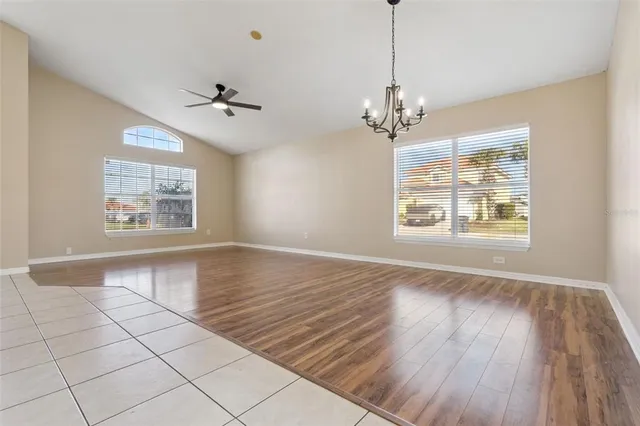 a kitchen with granite countertop a stove top oven microwave and cabinets