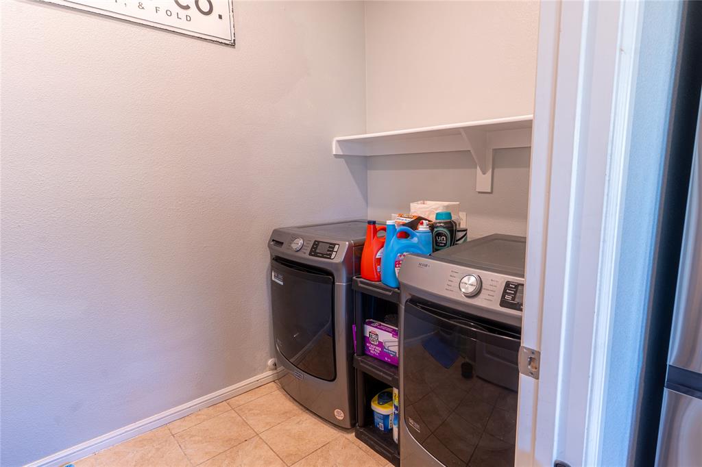 753 Rutherford Drive Crowley, TX 76036 - Photo 11 of 26 Dedicated laundry area featuring a white wall shelf, neutral wall color, and tile flooring