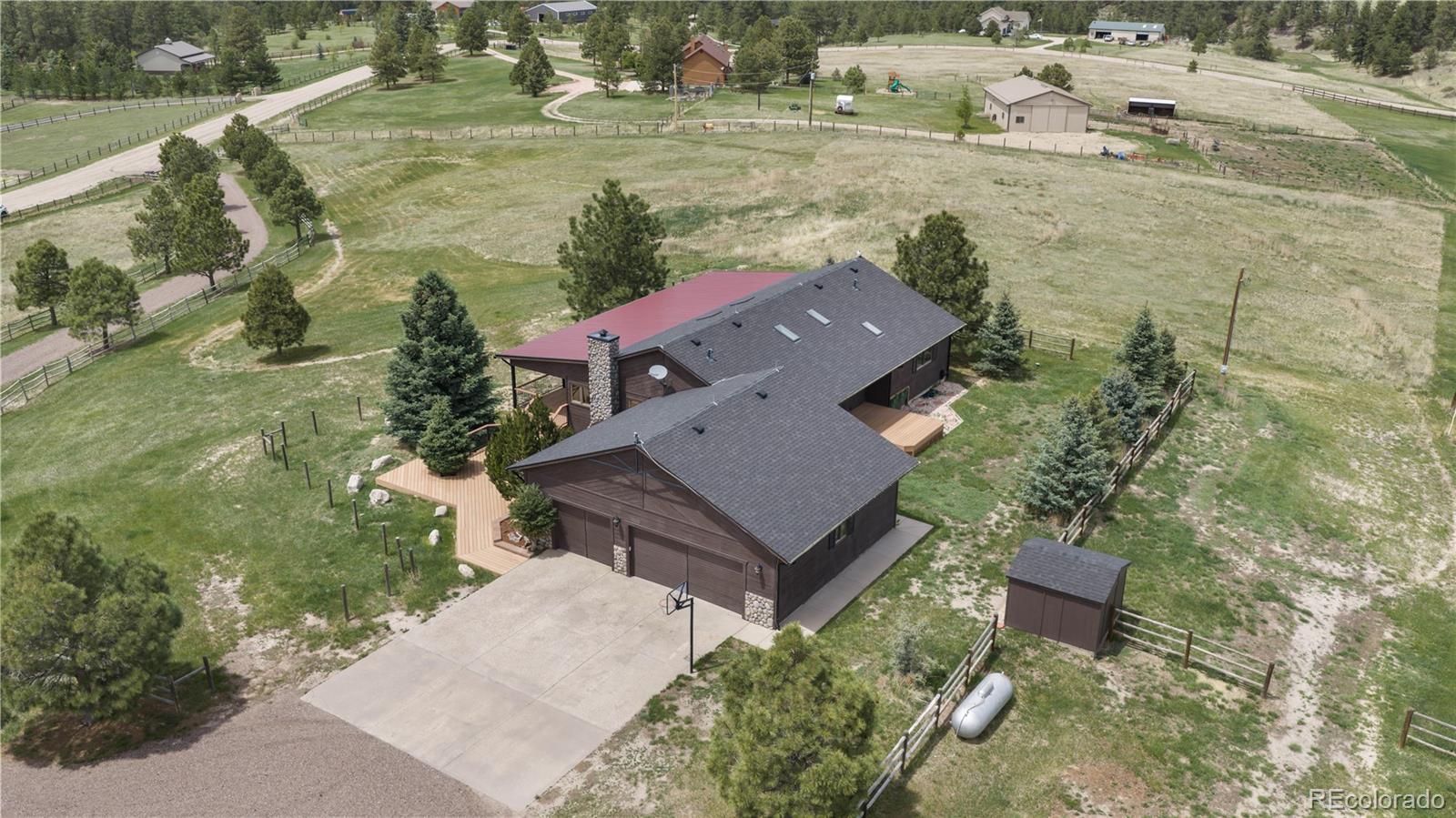 74 Rocky Cliff Road Elizabeth, CO 80107 - Photo 42 of 50 an aerial view of a house with a yard and lake view