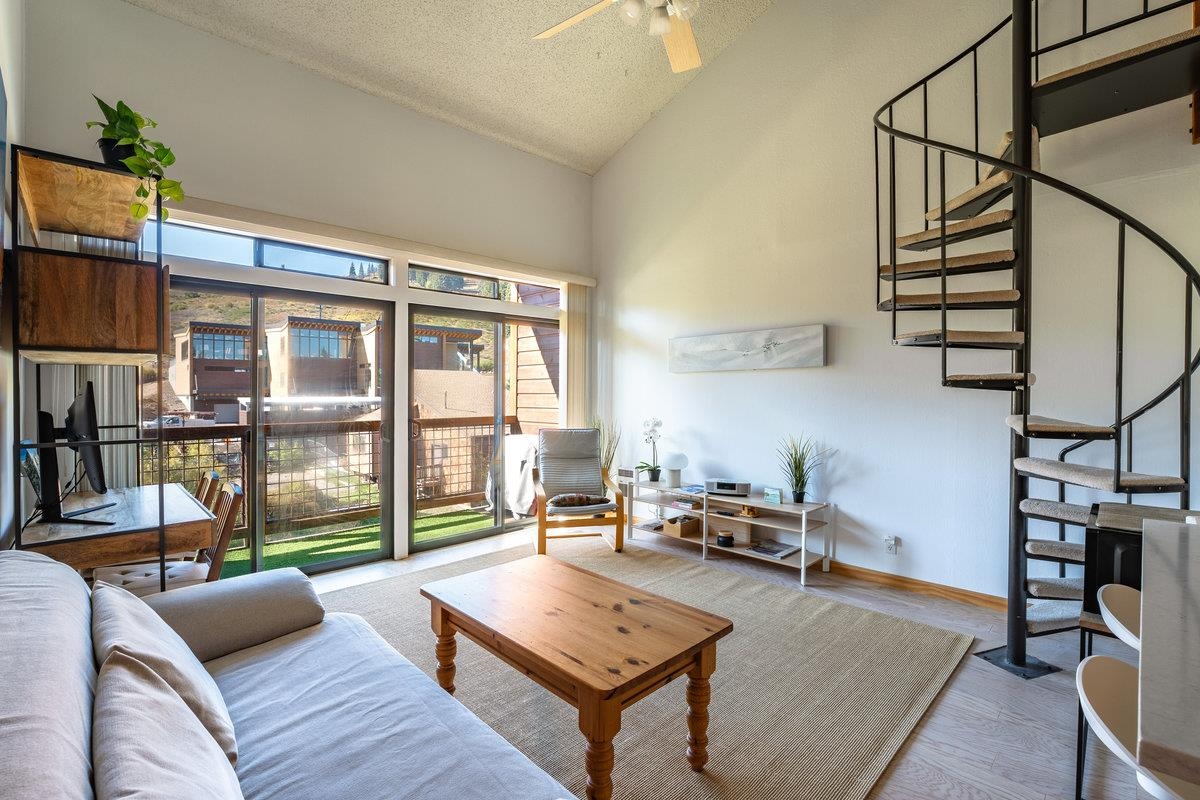 11591 Snowpeak Way, Unit 407 Truckee, CA 96161 - Photo 1 of 14 a living room with furniture and a floor to ceiling window