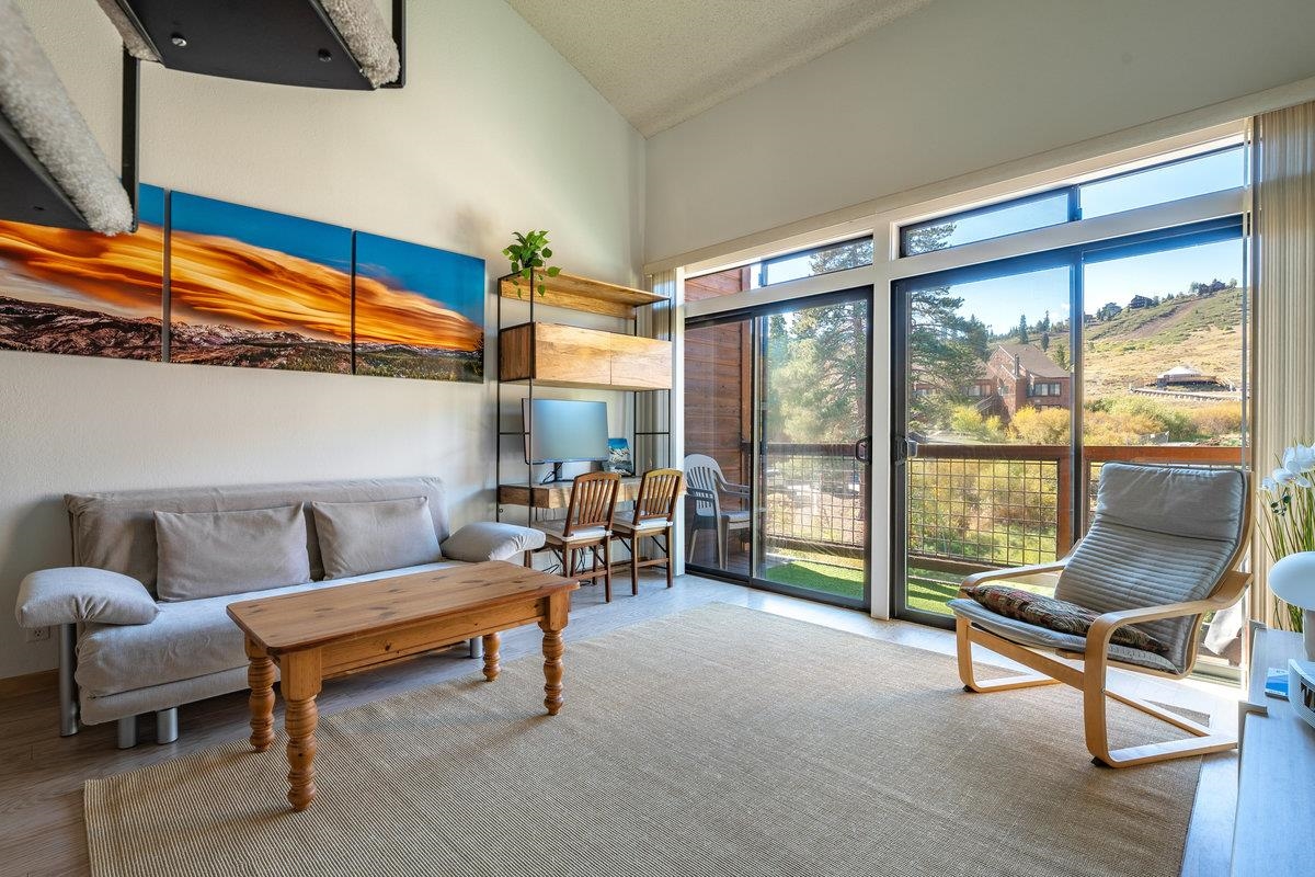 11591 Snowpeak Way, Unit 407 Truckee, CA 96161 - Photo 2 of 14 a living room with furniture and a floor to ceiling window