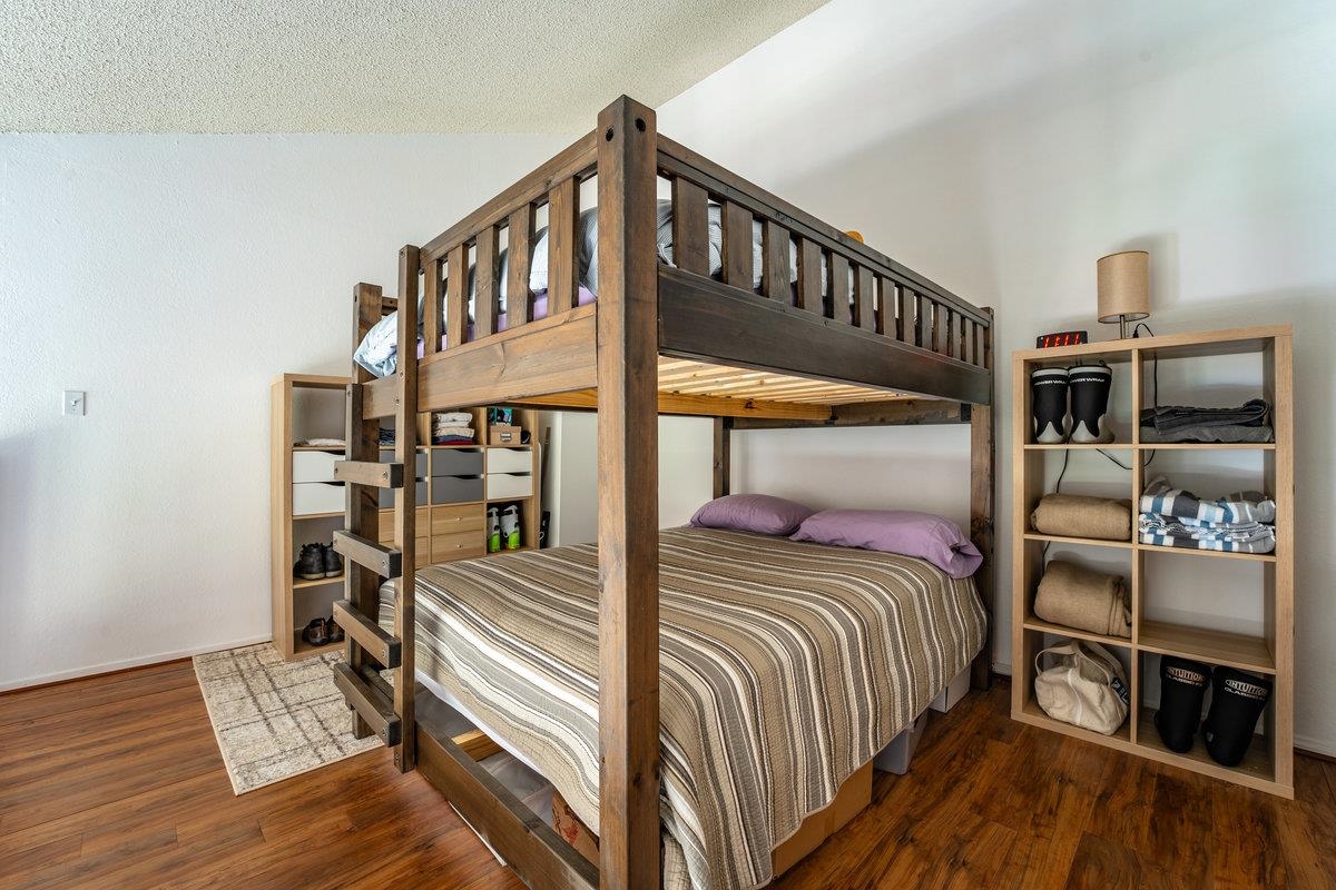 11591 Snowpeak Way, Unit 407 Truckee, CA 96161 - Photo 7 of 14 a view of a bedroom with furniture and staircase