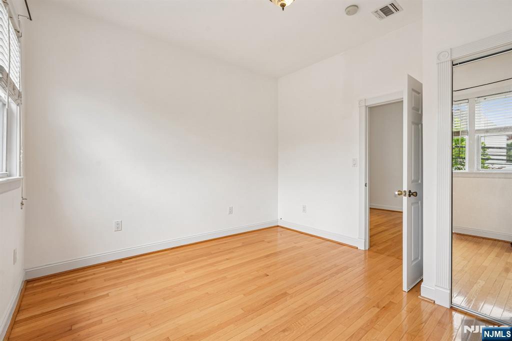 90 A Hackensack Plank Road Weehawken, NJ 07086 - Photo 25 of 40 an empty room with wooden floor and closet