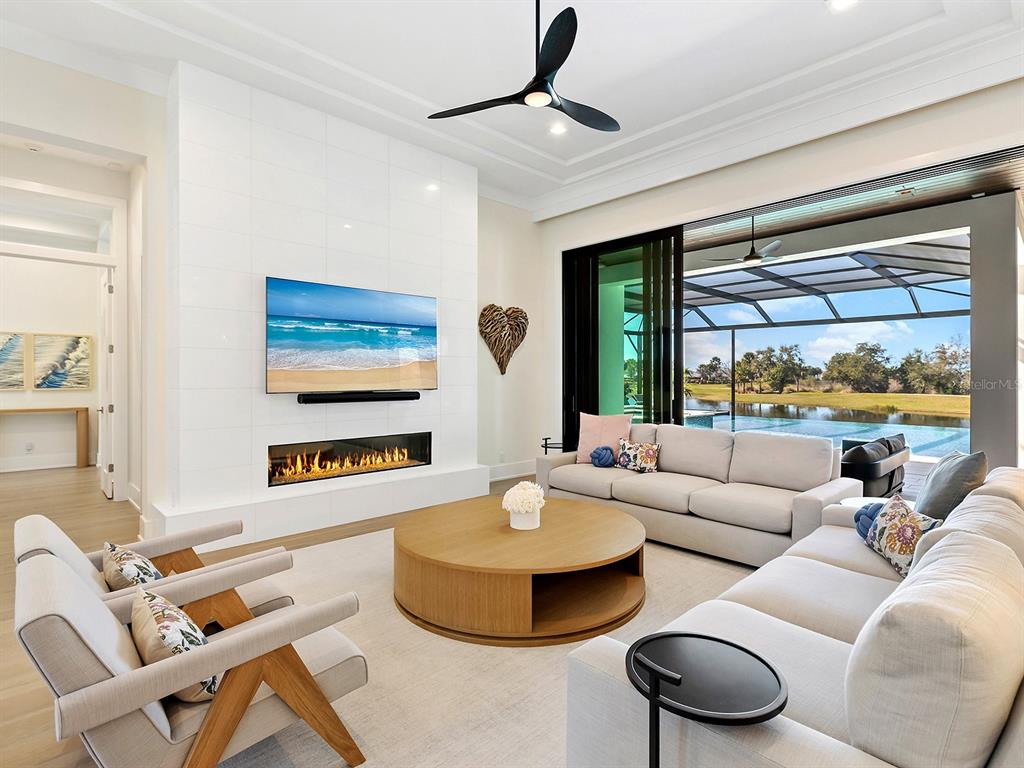 4218 Butte Trail Lakewood Ranch, FL 34211 - Photo 14 of 89 a living room with furniture and a large window