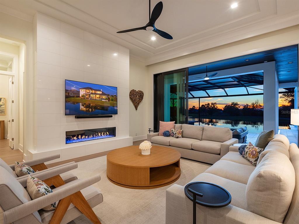 4218 Butte Trail Lakewood Ranch, FL 34211 - Photo 16 of 89 a living room with furniture and a flat screen tv