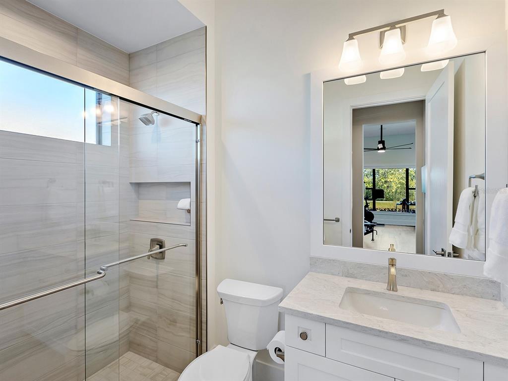 4218 Butte Trail Lakewood Ranch, FL 34211 - Photo 36 of 89 a bathroom with a sink toilet and shower