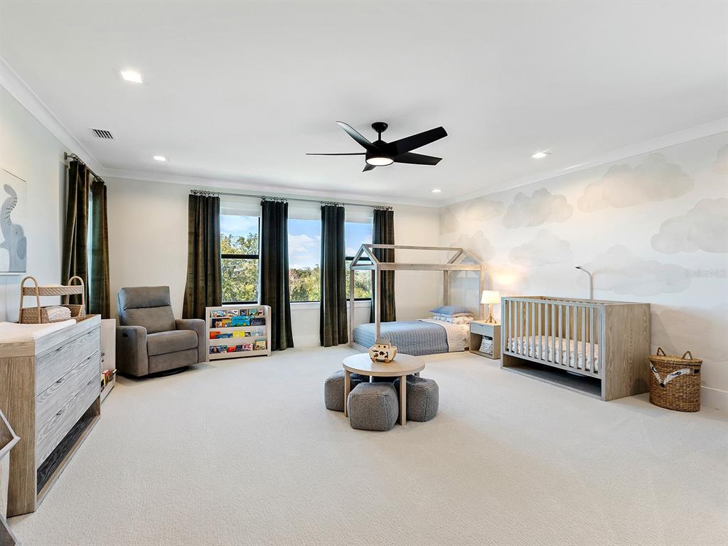 4218 Butte Trail Lakewood Ranch, FL 34211 - Photo 51 of 89 a living room with furniture and a chandelier
