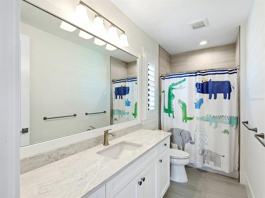 4218 Butte Trail Lakewood Ranch, FL 34211 - Photo 53 of 89 a bathroom with a granite countertop sink mirror vanity and toilet