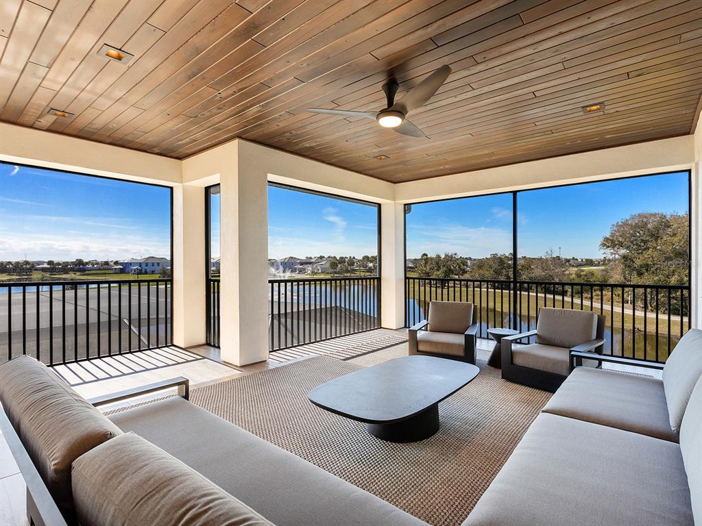 4218 Butte Trail Lakewood Ranch, FL 34211 - Photo 59 of 89 a living room with furniture and a floor to ceiling window