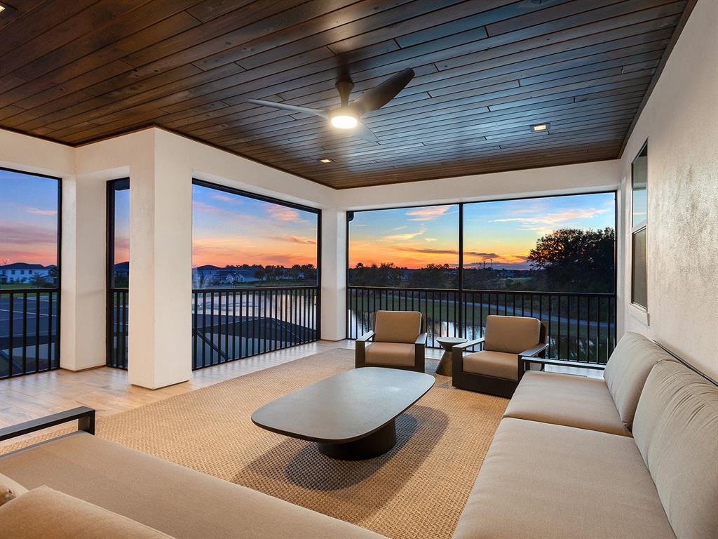 4218 Butte Trail Lakewood Ranch, FL 34211 - Photo 60 of 89 a balcony with furniture and a ceiling fan