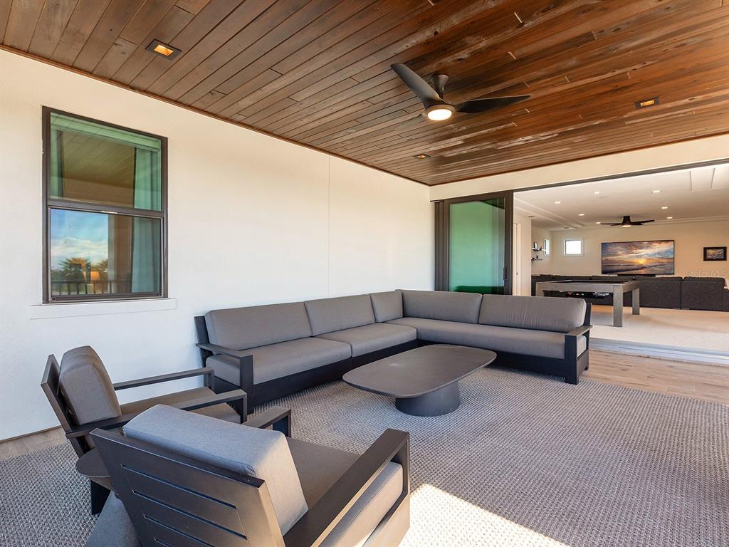 4218 Butte Trail Lakewood Ranch, FL 34211 - Photo 61 of 89 a living room with furniture and a chandelier