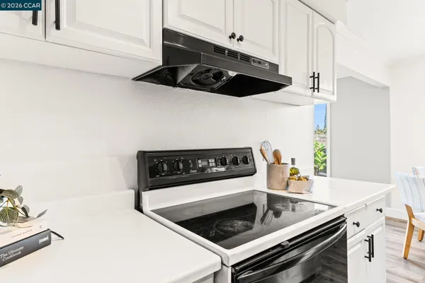 a kitchen with granite countertop a stove and a microwave