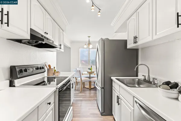 a kitchen with stainless steel appliances a sink a stove and a refrigerator