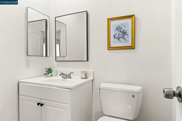 a bathroom with a toilet a sink and a mirror