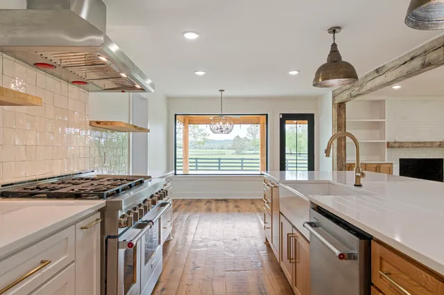 a kitchen with granite countertop a stove and a sink