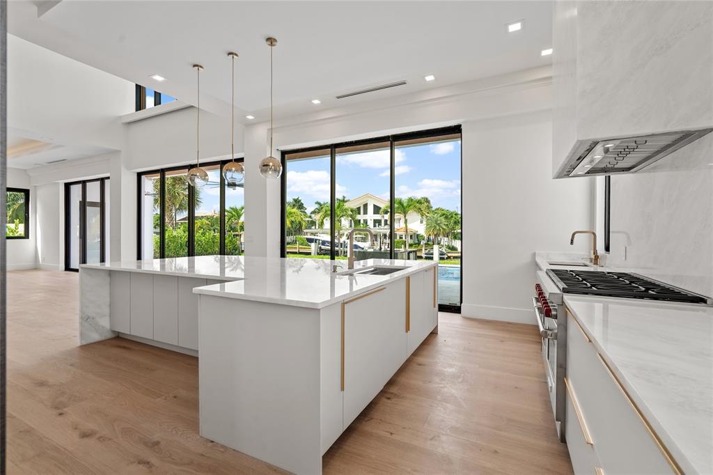 2 Sunset Lane Lauderdale-by-the-Sea, FL 33062 - Photo 12 of 79 a kitchen with stainless steel appliances a stove a sink and a refrigerator