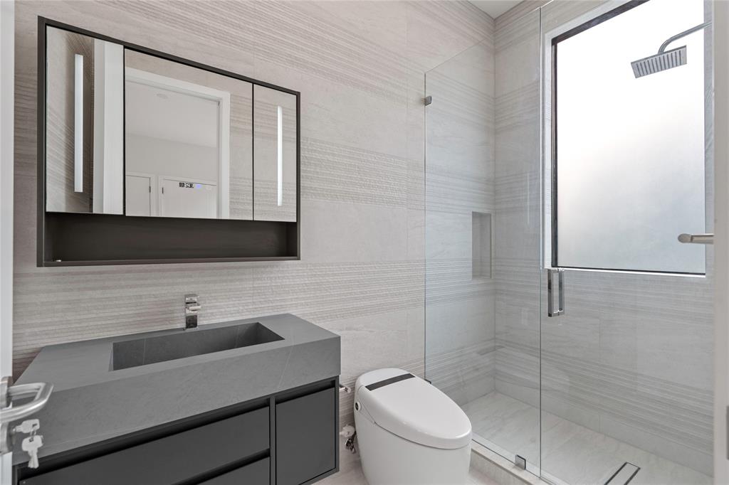 2 Sunset Lane Lauderdale-by-the-Sea, FL 33062 - Photo 18 of 79 a bathroom with a toilet a sink and mirror