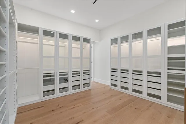 an empty room with windows and closet
