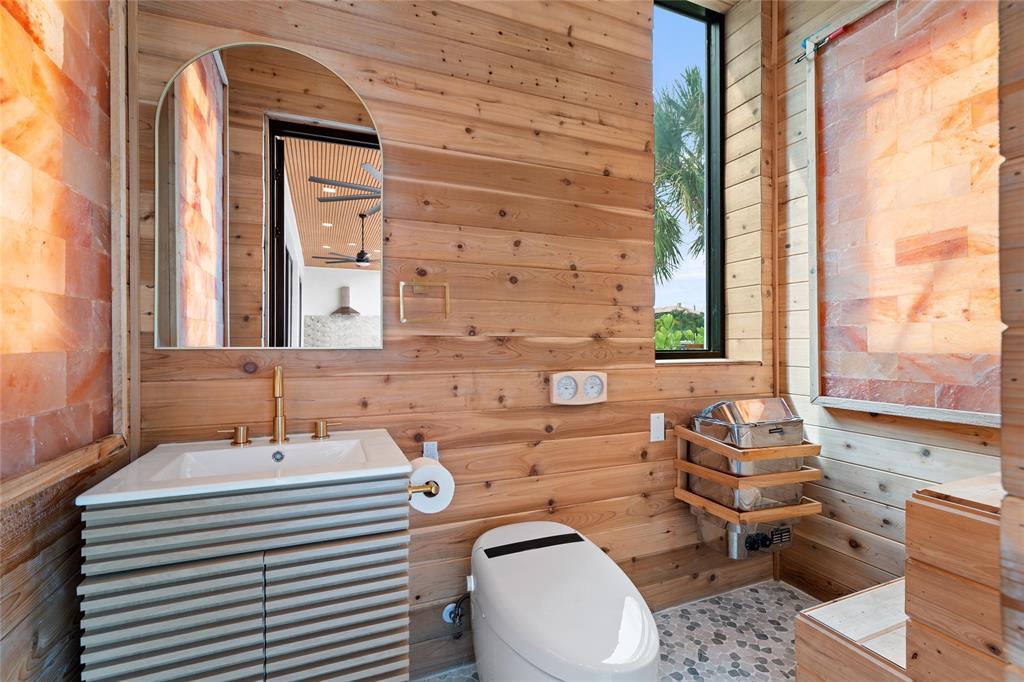 2 Sunset Lane Lauderdale-by-the-Sea, FL 33062 - Photo 44 of 79 a bathroom with a sink a toilet and mirror