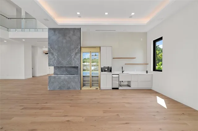 a large kitchen with stainless steel appliances granite countertop a lot of counter space and wooden floor