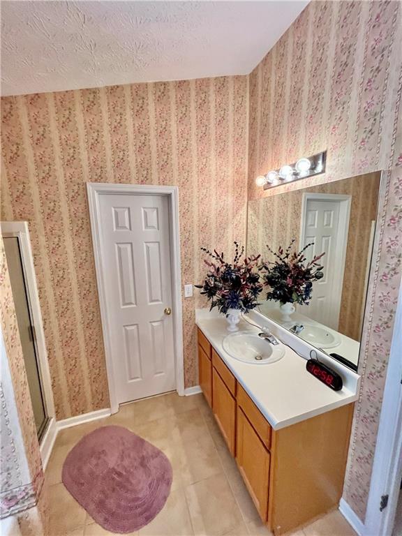19 Meadow Crest Court Powder Springs, GA 30127 - Photo 12 of 26 a bathroom with a sink and mirror with bathtub
