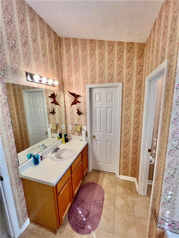19 Meadow Crest Court Powder Springs, GA 30127 - Photo 13 of 26 a bathroom with a sink a vanity and a mirror