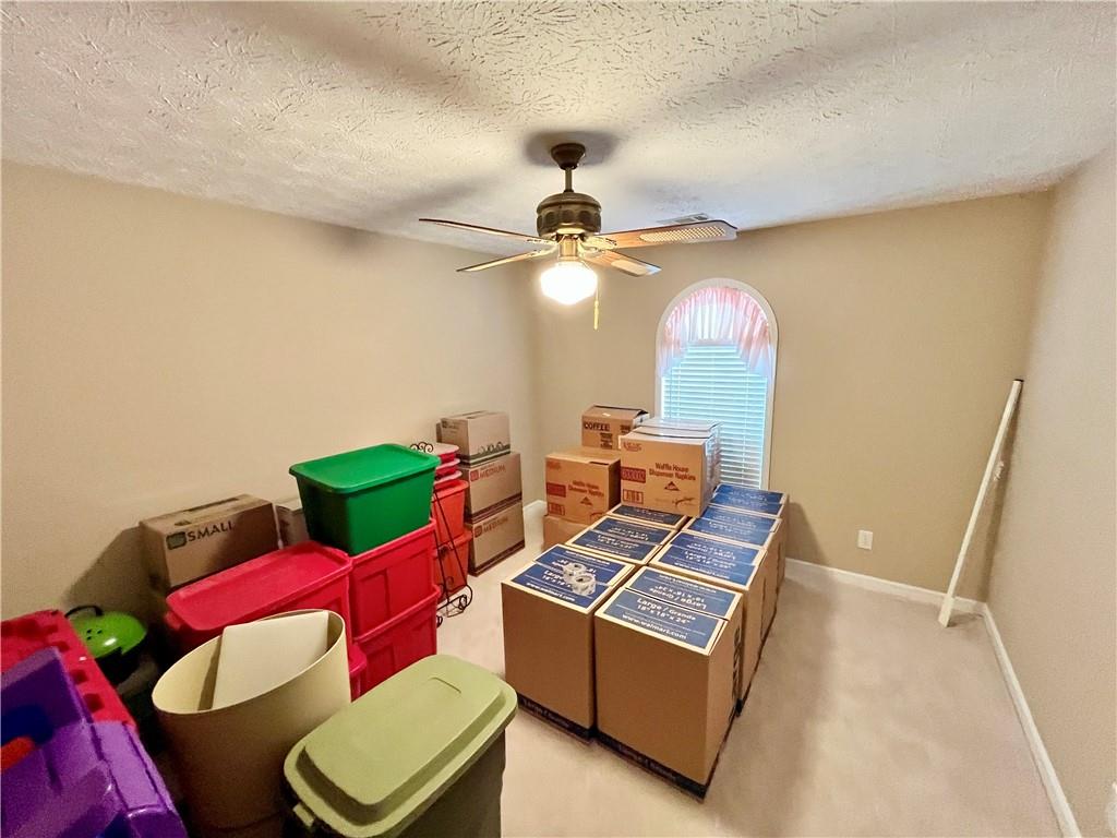 19 Meadow Crest Court Powder Springs, GA 30127 - Photo 18 of 26 a living room with furniture and a chandelier