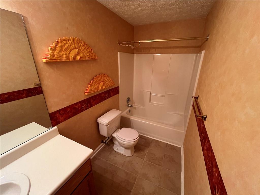 19 Meadow Crest Court Powder Springs, GA 30127 - Photo 19 of 26 a bathroom with a sink toilet and shower
