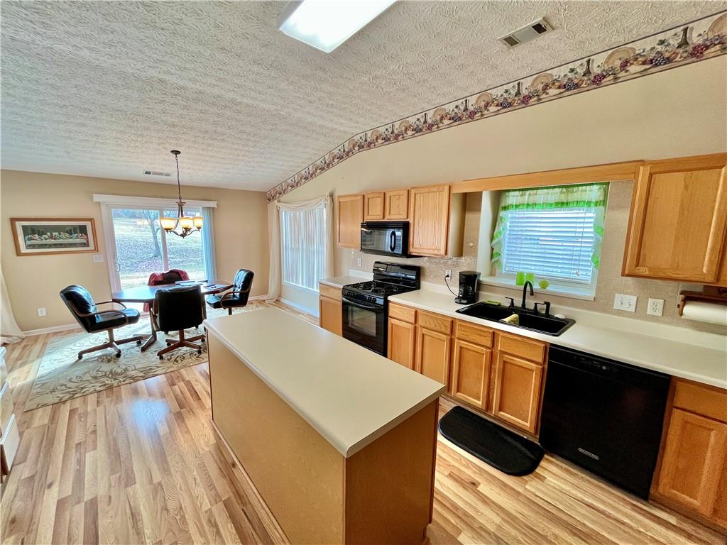 19 Meadow Crest Court Powder Springs, GA 30127 - Photo 8 of 26 a large kitchen with a table chairs refrigerator and a sink