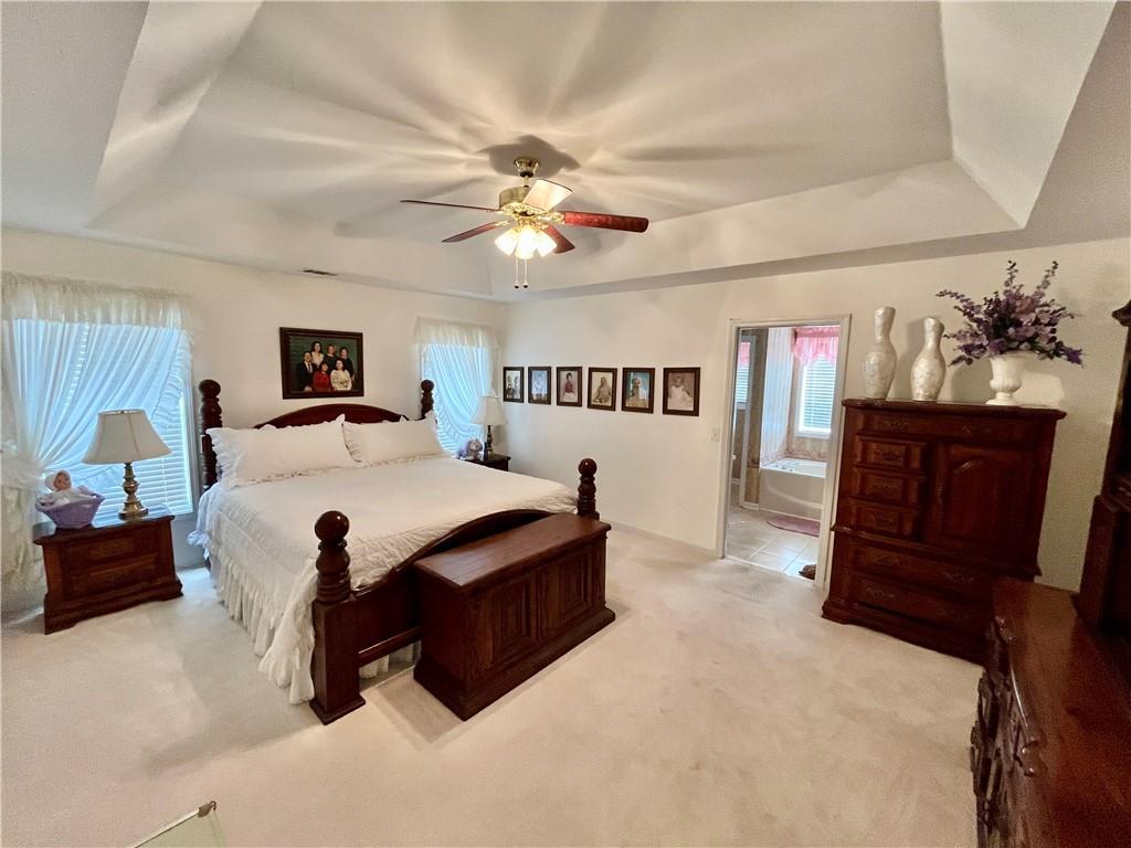 19 Meadow Crest Court Powder Springs, GA 30127 - Photo 10 of 26 a bedroom with a bed and a chandelier