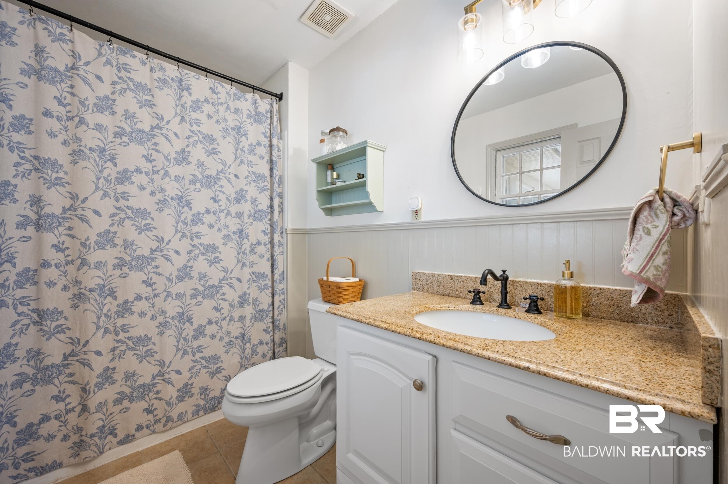 809 Moog Avenue Bay Minette, AL 36507 - Photo 23 of 33 Full bath with vanity, wainscoting, curtained shower, and light tile patterned flooring