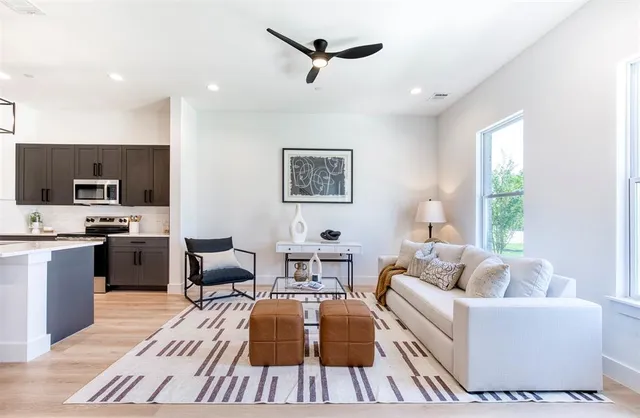 a living room with furniture and kitchen view