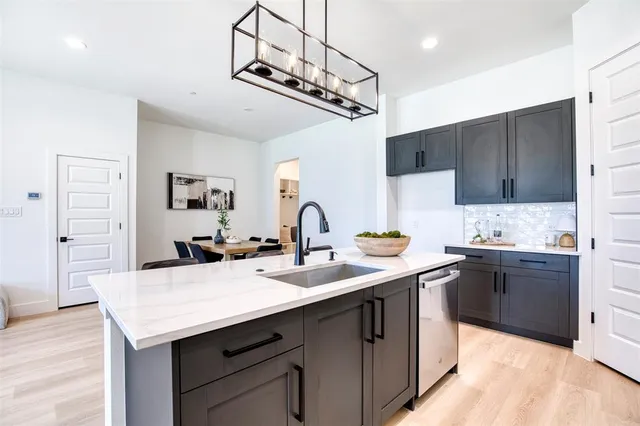 a kitchen with a sink a stove and cabinets