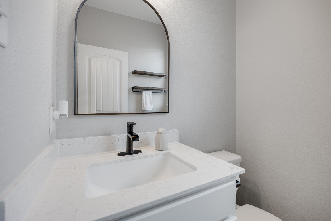 214 Saranac Drive Elgin, TX 78621 - Photo 24 of 37 a bathroom with a sink toilet and mirror