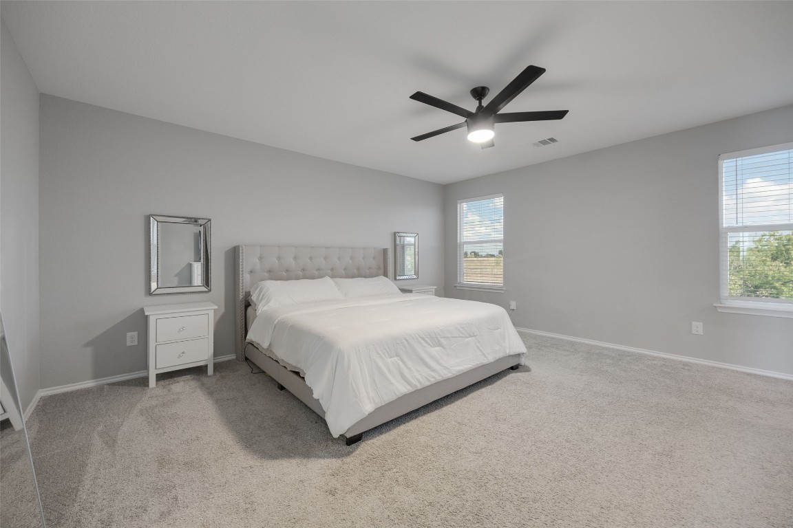 214 Saranac Drive Elgin, TX 78621 - Photo 27 of 37 a spacious bedroom with a bed and window