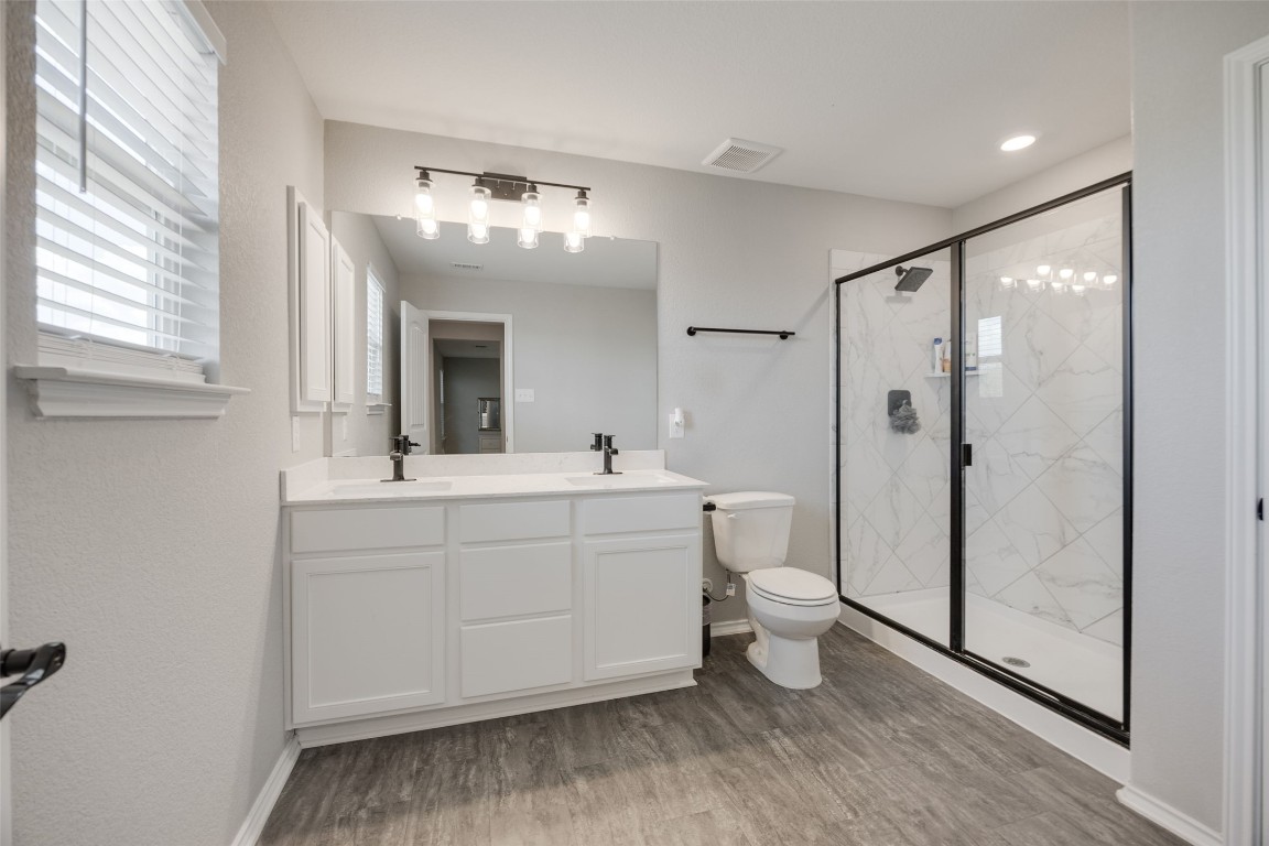 214 Saranac Drive Elgin, TX 78621 - Photo 28 of 37 a bathroom with a double vanity sink mirror and toilet