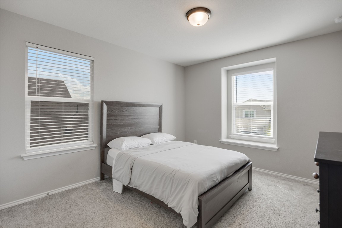 214 Saranac Drive Elgin, TX 78621 - Photo 31 of 37 a bedroom with a bed and a window