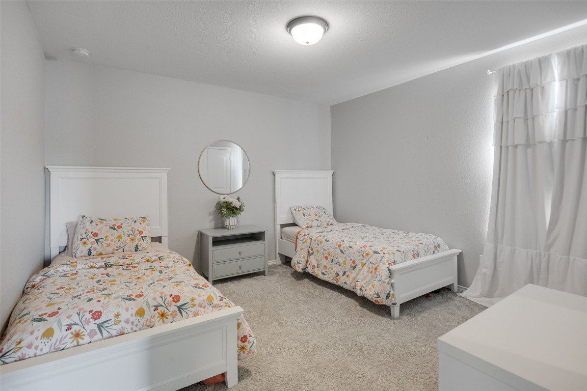 214 Saranac Drive Elgin, TX 78621 - Photo 32 of 37 a bedroom with two beds and painted walls