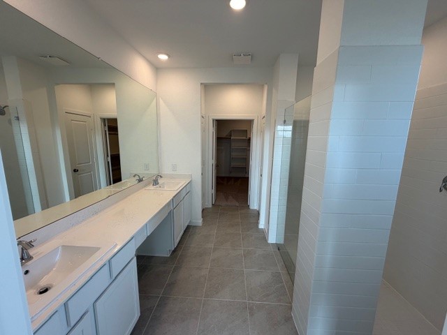 5518 Red Snapper Drive Baytown, TX 77521 - Photo 2 of 11 a bathroom with a double vanity sink and mirror