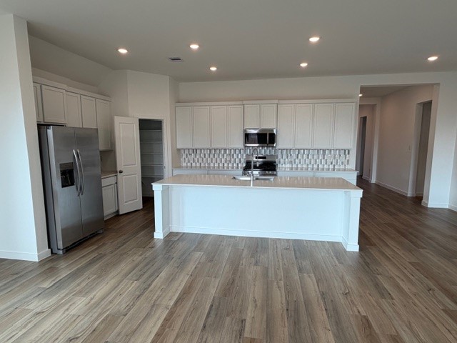 5518 Red Snapper Drive Baytown, TX 77521 - Photo 5 of 11 a large kitchen with stainless steel appliances a large counter top a refrigerator and a sink