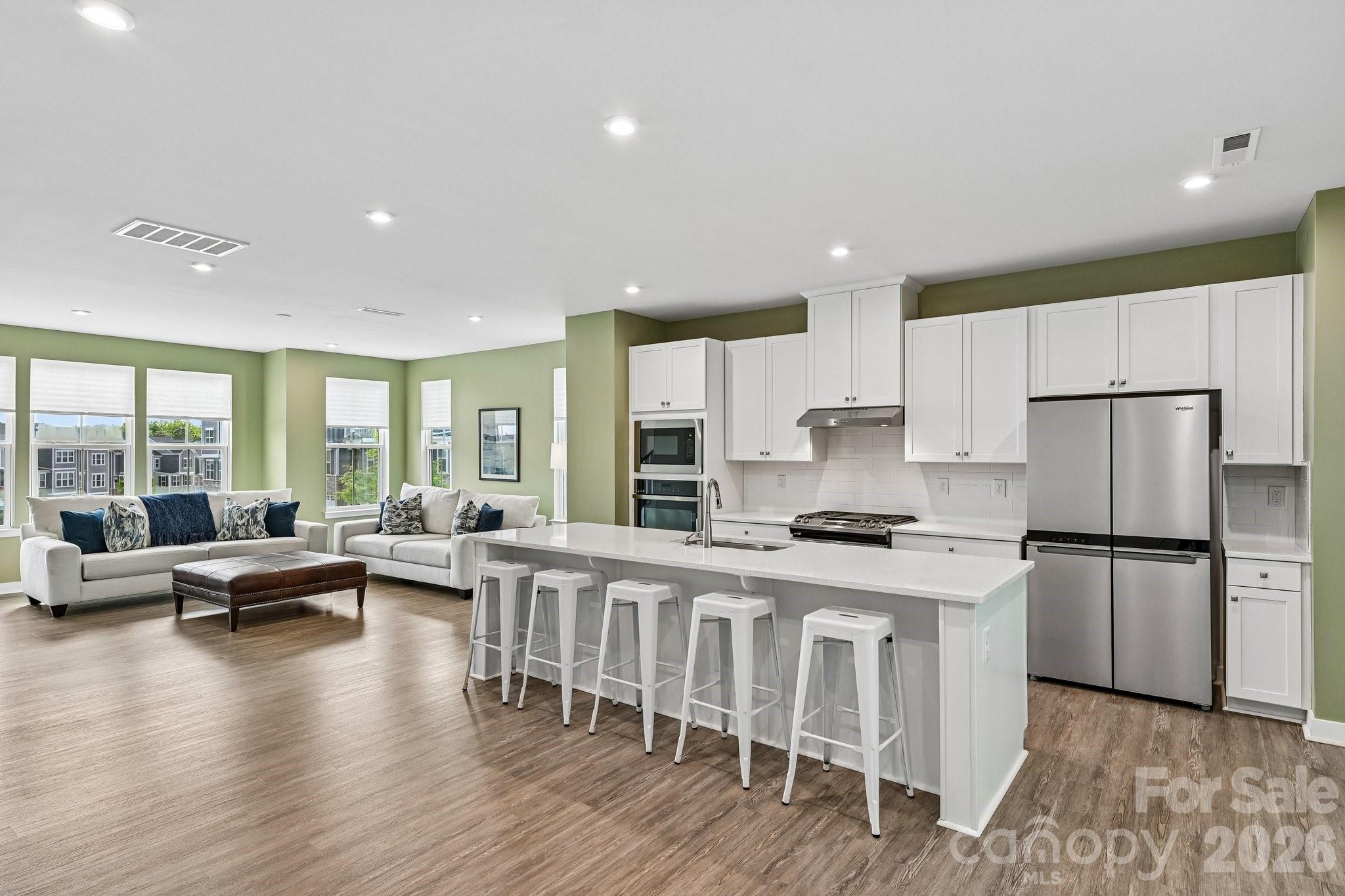 957 Portrush Lane Tega Cay, SC 29708 - Photo 5 of 39 a kitchen with stainless steel appliances granite countertop a stove a refrigerator a kitchen island a stove and a refrigerator